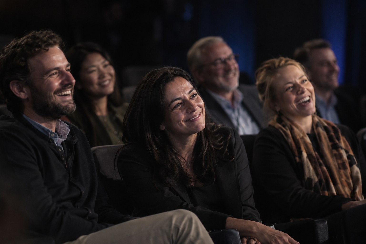 Audience members laughing during a talk
